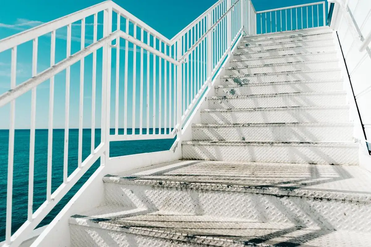 Bright staircase with railings representing levels of care