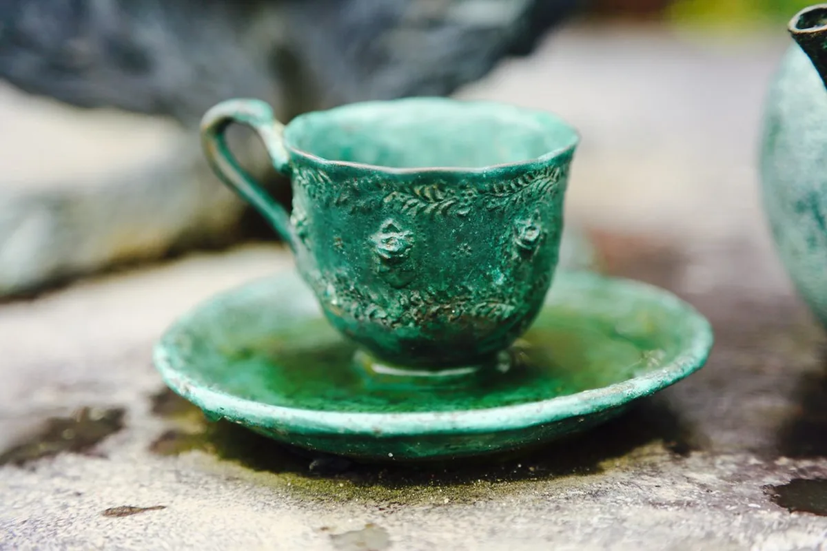 Green teacup on a saucer for a quiet caregiver break