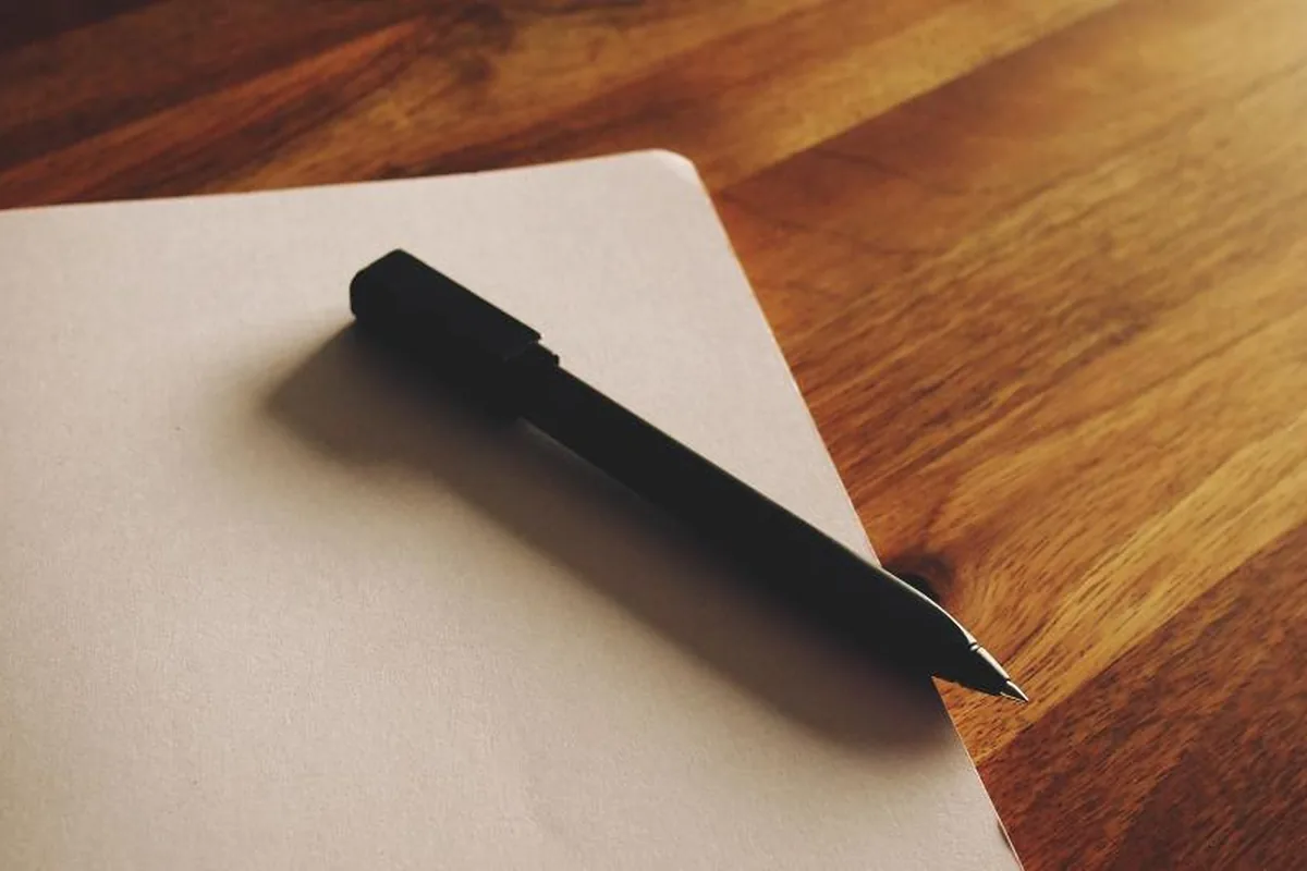 Blank notepad and pen for writing questions before hiring in-home care