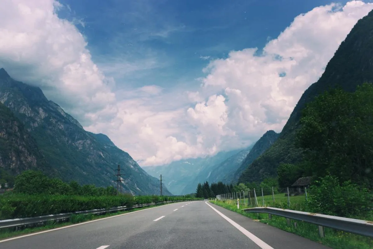 Open road through a valley for long-distance caregiving trips