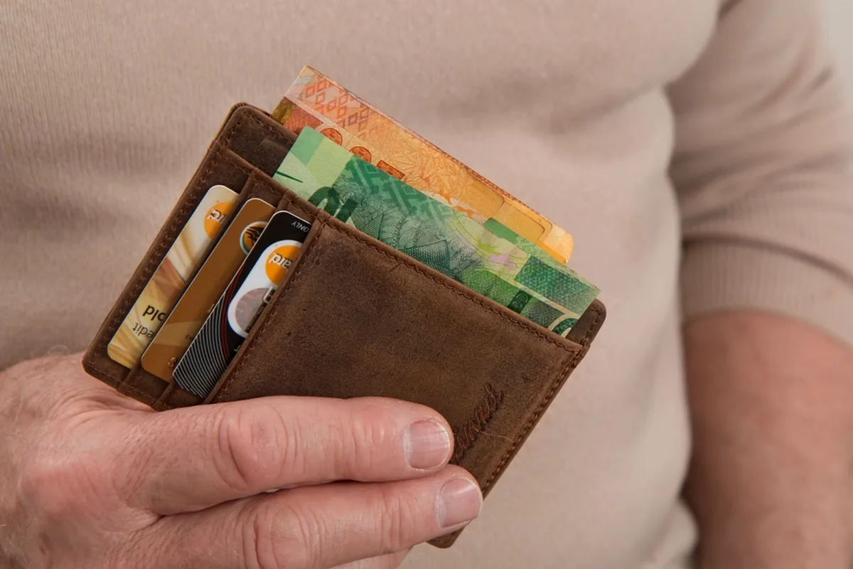 Hands opening a wallet for a private-pay care budget