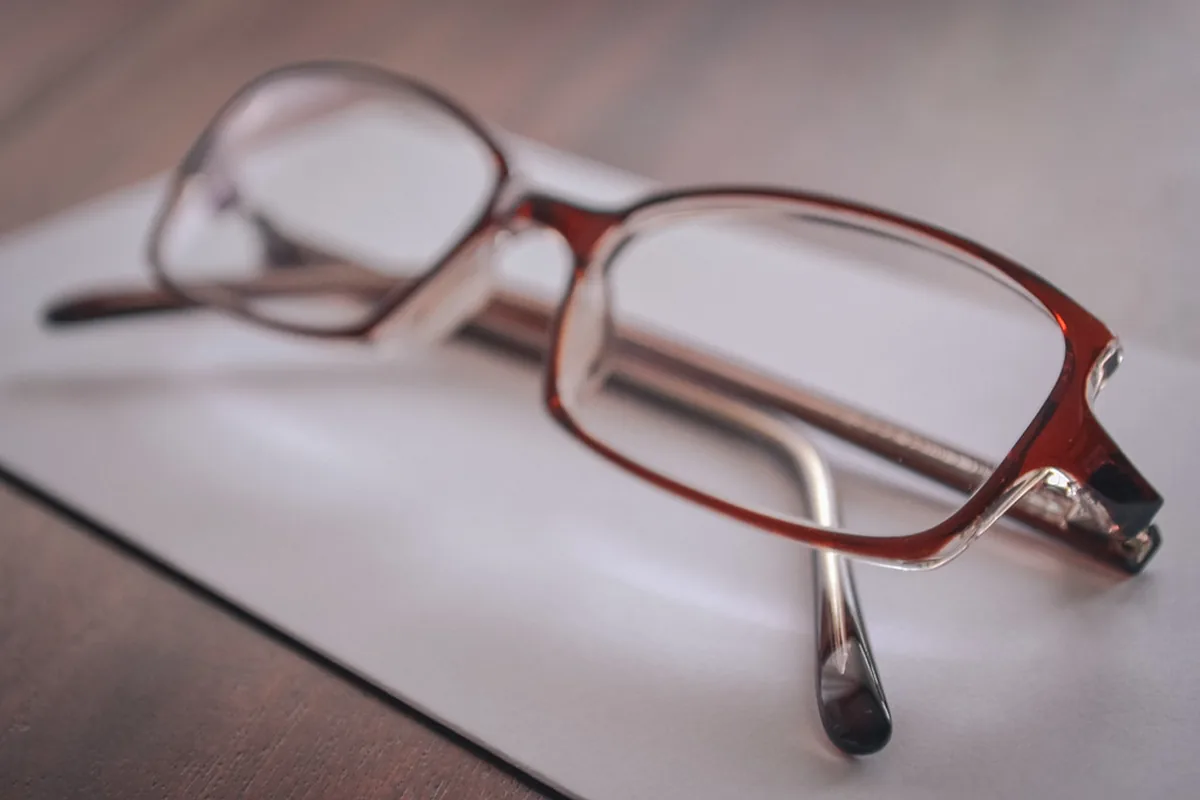 Reading glasses resting on paper, ready to review a contract