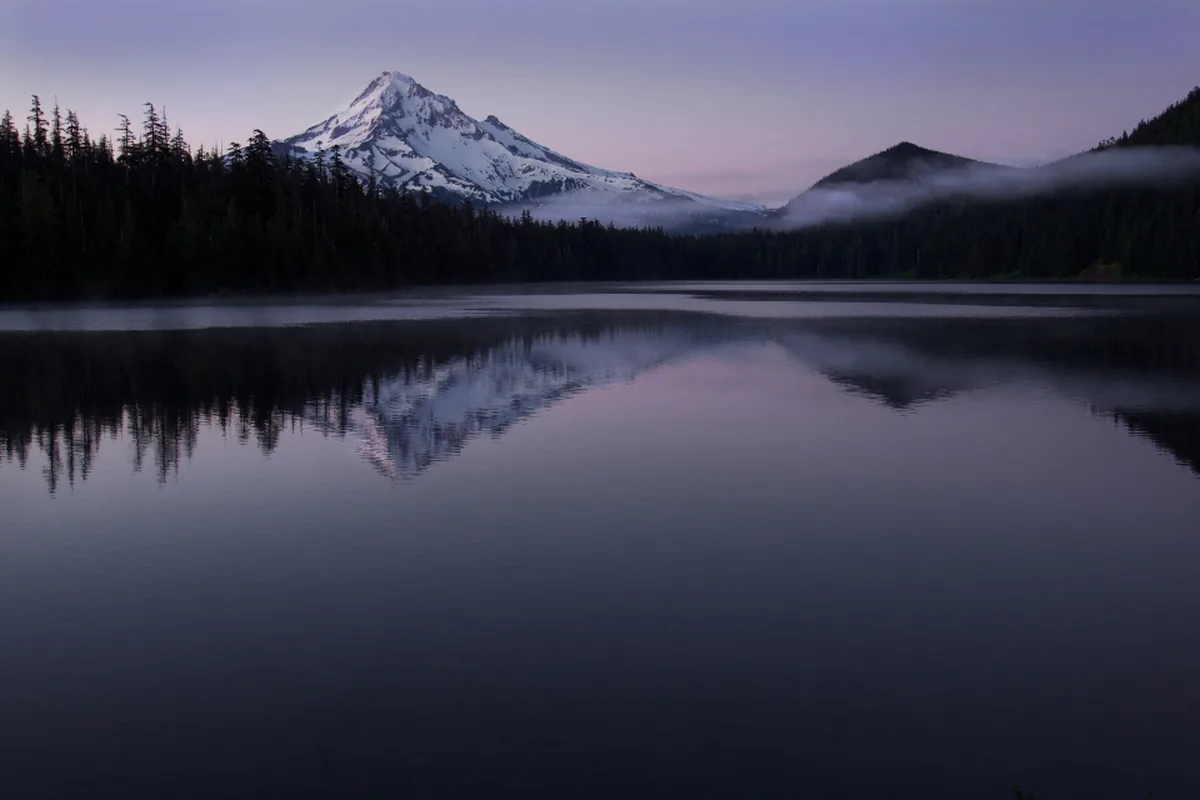 Calm mountain lake at dusk for a caregiver reset